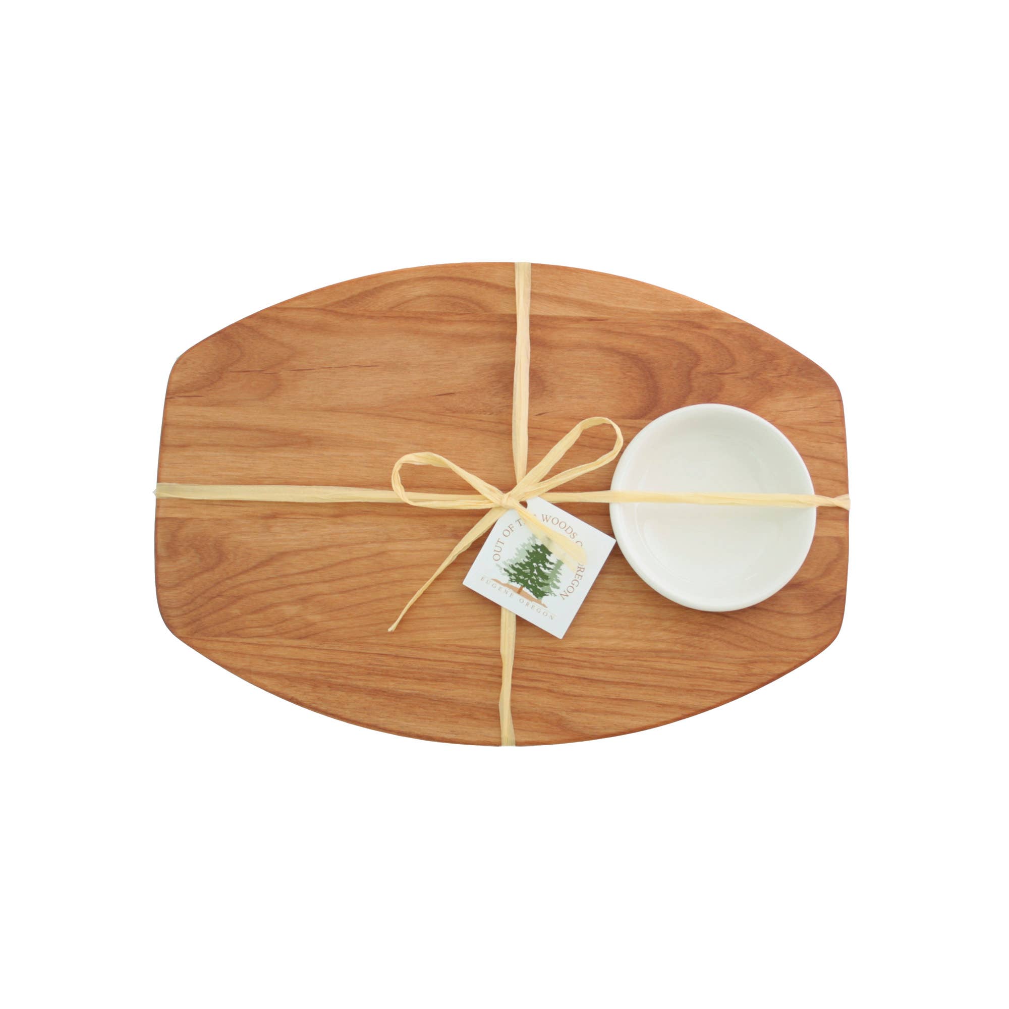 Wooden cutting board with a white bowl and decorative bow on a white background
