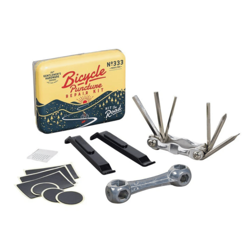 Bicycle puncture repair kit with tools and a tin on a white background