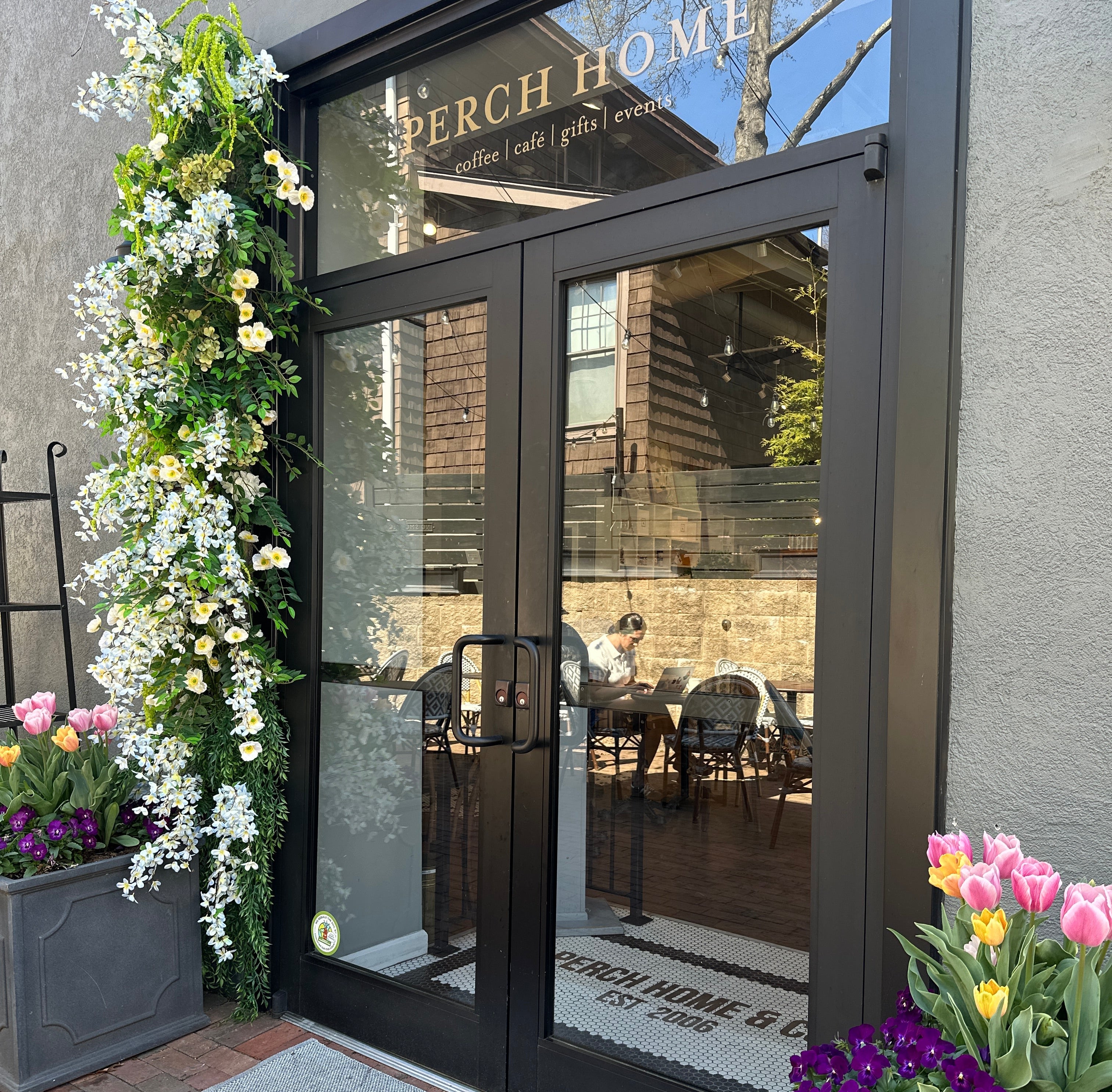 Decorative floral arrangements on a door with 'Beech Home' branding.