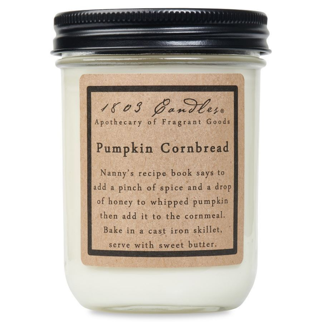 Jar of pumpkin cornbread candle with decorative label on a white background